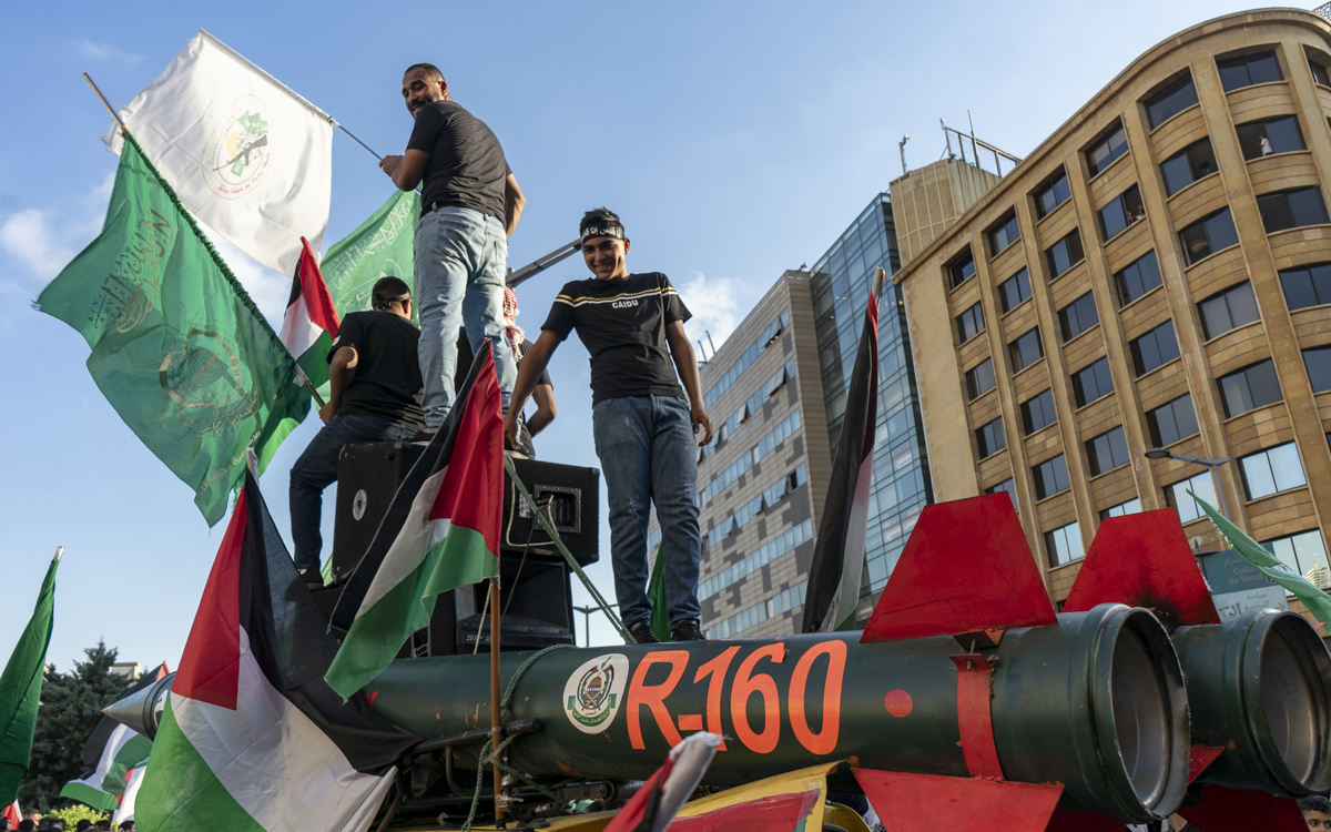 Protestors stand on fake R-160 rockets