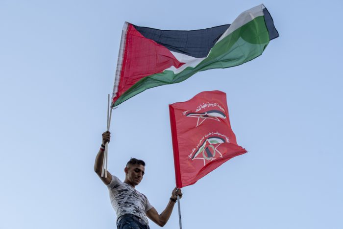 Man holds Palestinian Flag