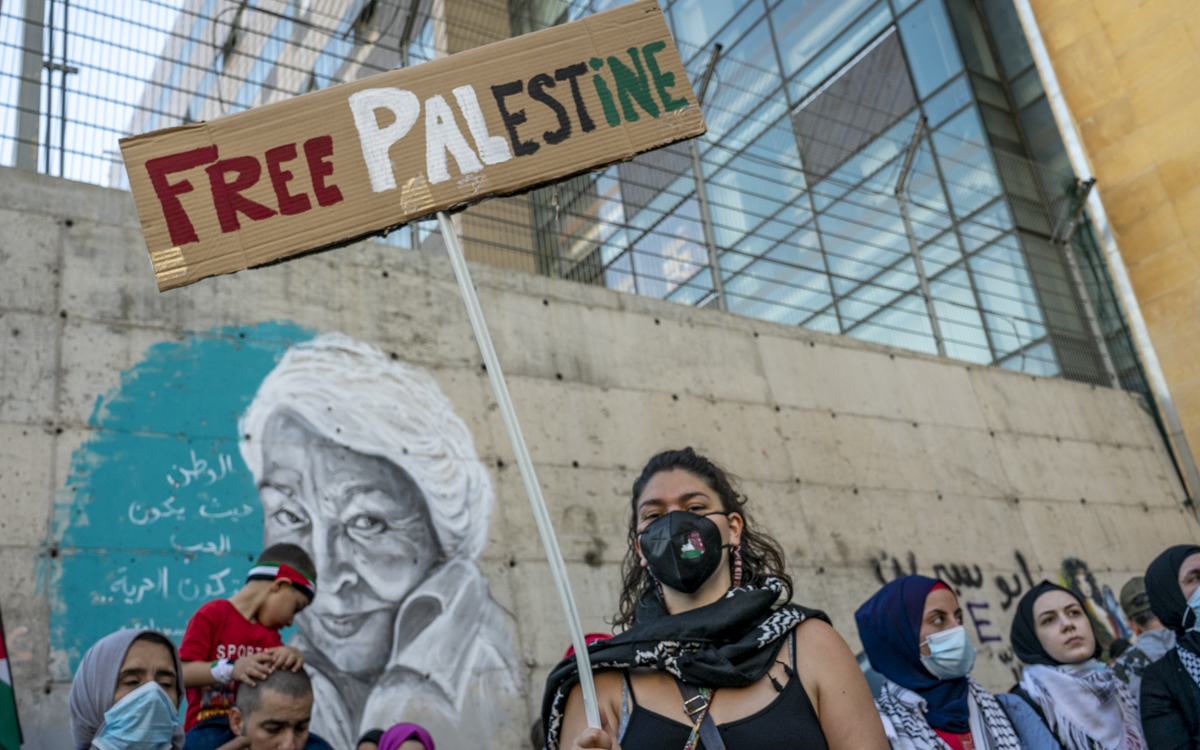 Woman holds sign saying 'Free Palestine'